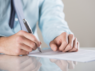 man signing legal papers