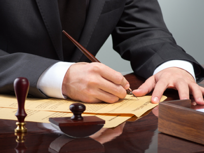 Lawyer signing corporate litigation papers