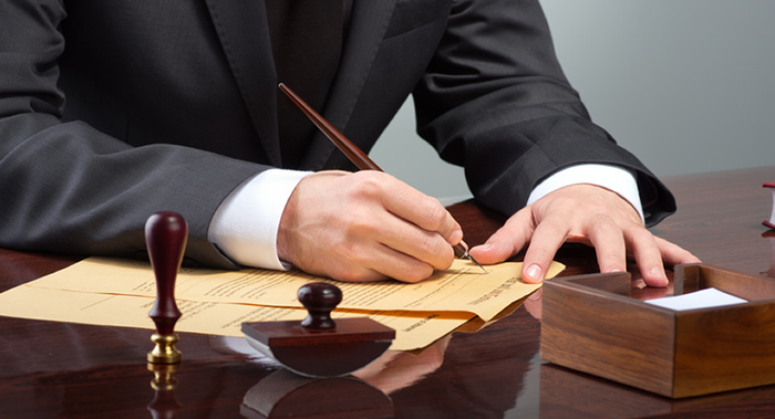Lawyer signing corporate litigation papers